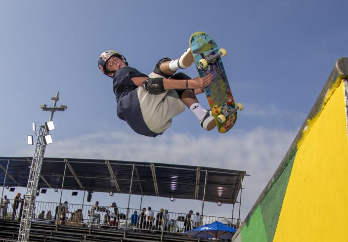 Skateboarding athlete performing a trick on the track