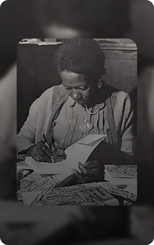 Photo of Carolina Maria de Jesus writing. She was a Black author who lived during the 20th century.